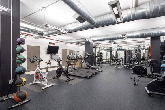 Interior view of a gym with exercise equipment and exercise machines.