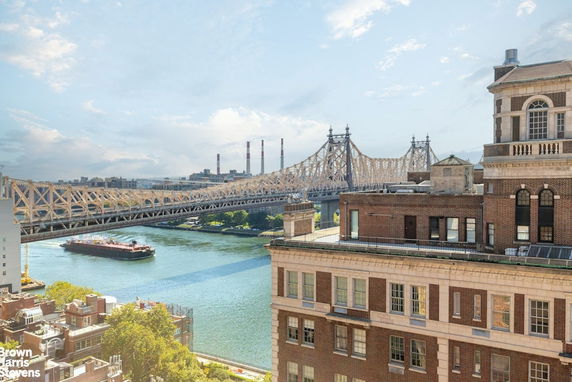 View of a bridge and river seen from a building rooftop.
