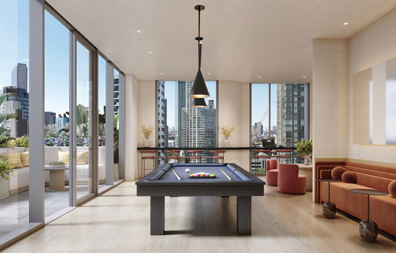 Interior view of a recreation area with a pool table and seating.