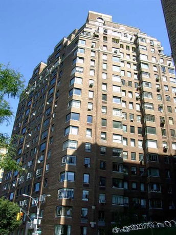 Front view of a high-rise apartment building with multiple windows.