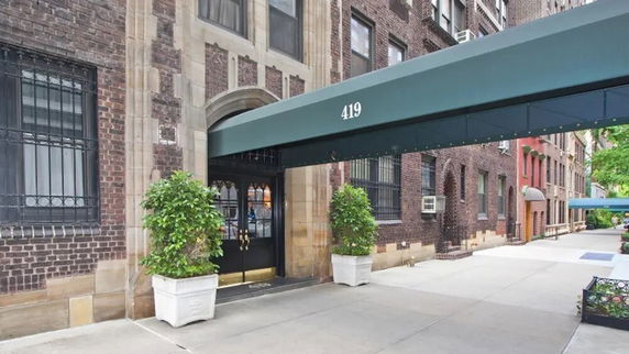 Front view of a building with an entrance canopy and brick facade.