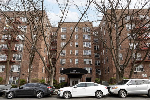 Front view of a multi-story brick apartment building.