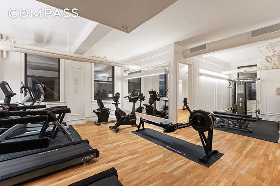 Room with treadmills, exercise bikes, and fitness equipment.