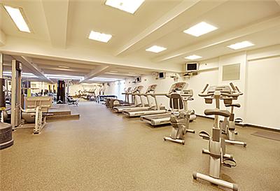 Indoor gym area with various exercise equipment.