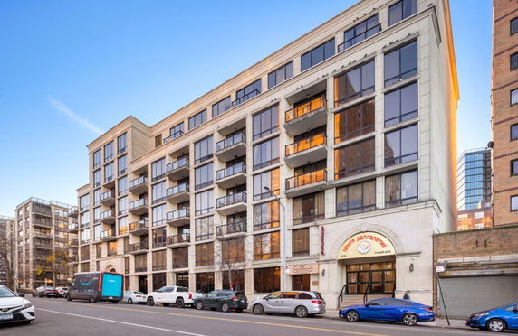 Front view of a multi-story building with balconies.