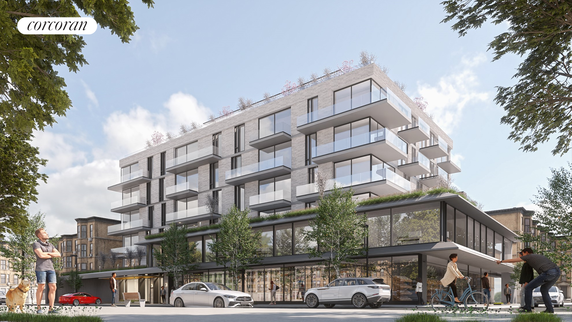 Front view of a modern multi-story residential building with glass balconies.