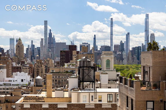 Panoramic view of a city skyline with tall buildings and rooftops.