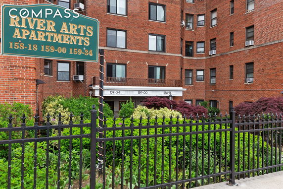 Front view of a multi-story brick apartment building.