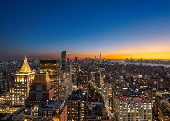 Wide angle view of city skyline at sunset.