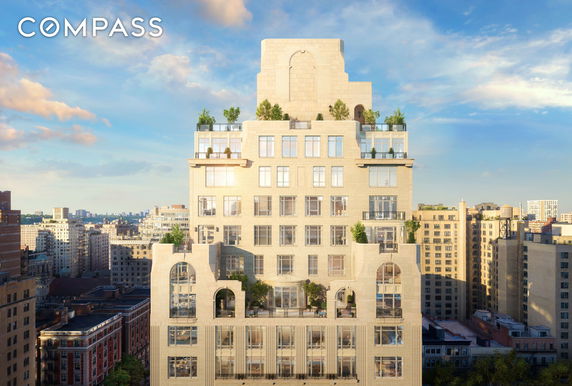 Front view of a multi-story building with balconies and rooftop greenery.