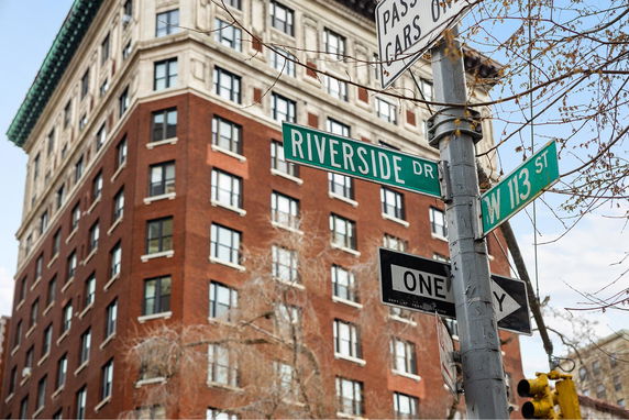 Front view of a multi-story brick building at an intersection.