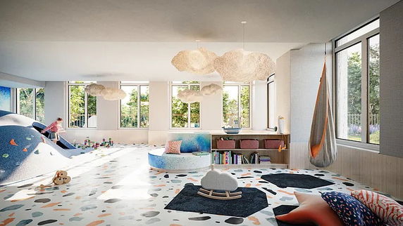 Indoor children's play area with climbing features and soft seating.