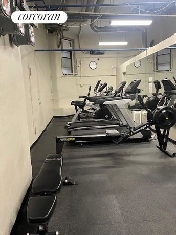 Indoor gym area with exercise equipment and benches.