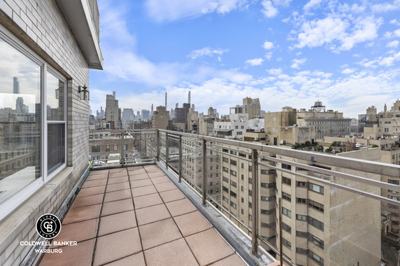 View of surrounding cityscape from a rooftop balcony.