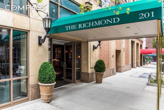 Entrance of a building with a green canopy labeled 'The Richmond 201'.