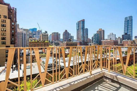 Panoramic view of city buildings from a balcony.