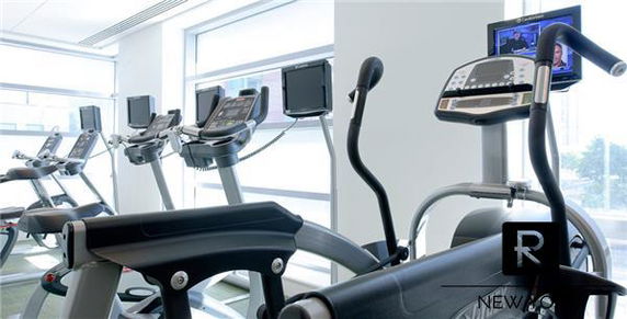 Indoor gym area with exercise machines in a building.