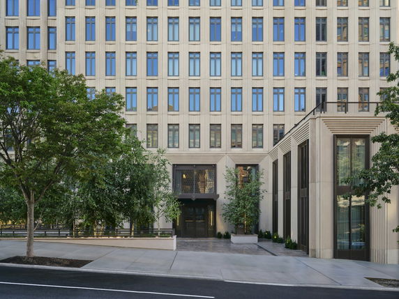 Front view of a multi-story building with large windows and a main entrance.