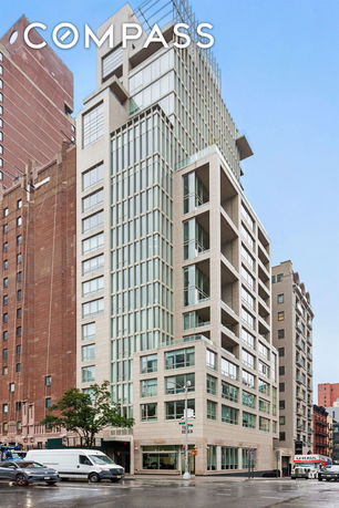 Front view of a multi-story apartment building in an urban setting.