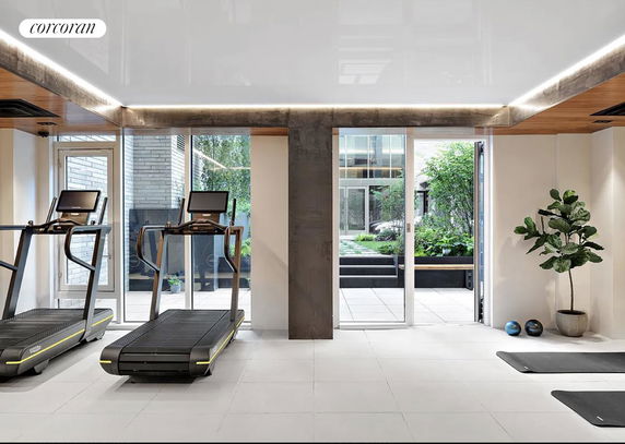 Indoor gym area with treadmills and exercise equipment.
