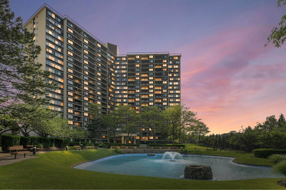 Front view of a multi-story residential building with numerous windows.