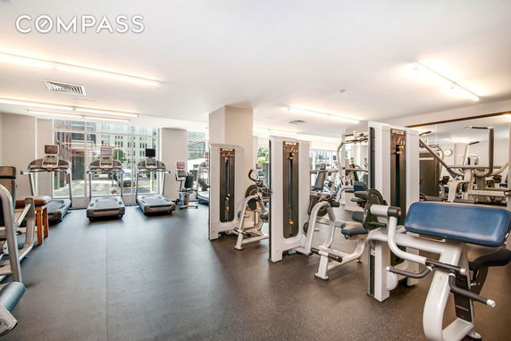 Interior view of a gym with treadmills and exercise machines.