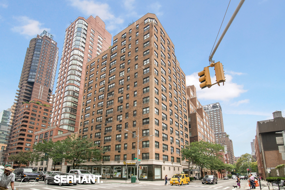 Front view of a multi-story apartment building in an urban setting.