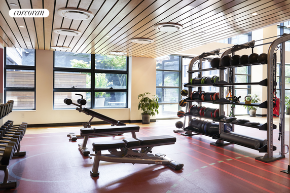 Indoor fitness area with exercise equipment and weights