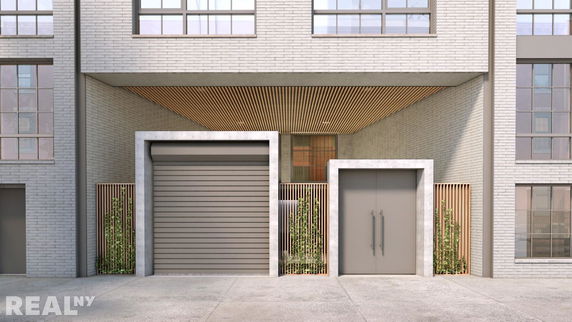 Front view of a building with large windows and a garage door.