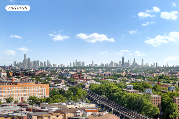 Panoramic view of a city skyline with numerous buildings and a clear blue sky.