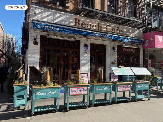 Front view of a cafe with a decorative facade and outdoor menu displays.