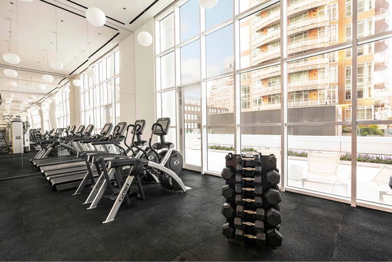 Interior view of a modern gym area with treadmills and exercise equipment.