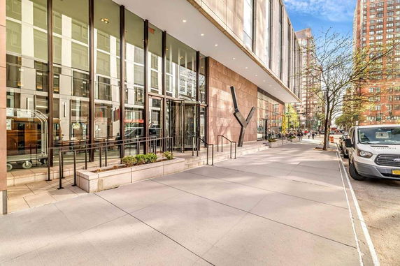 Front view of a modern building with large glass windows and a wide entrance.
