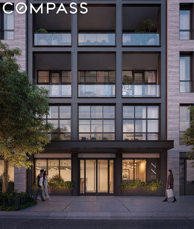 Front view of a modern multi-story building with large windows and balconies.