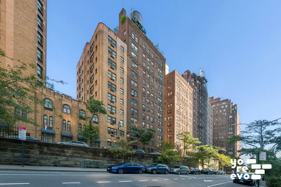 View of tall brick apartment buildings from the street.