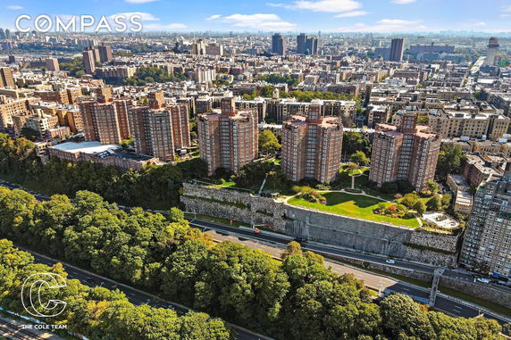 Aerial view of an urban area with several high-rise residential buildings surrounded by greenery and roads.