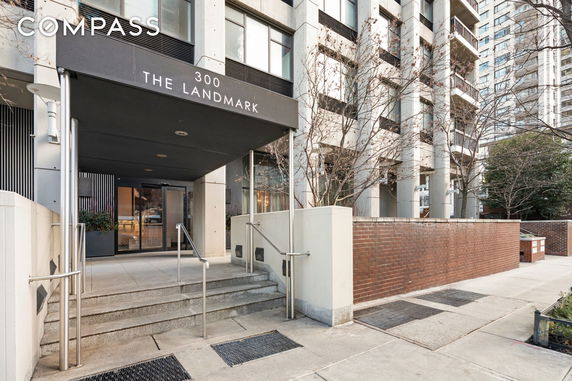 Front view of a multi-story apartment building with an entrance labeled '300 The Landmark.'