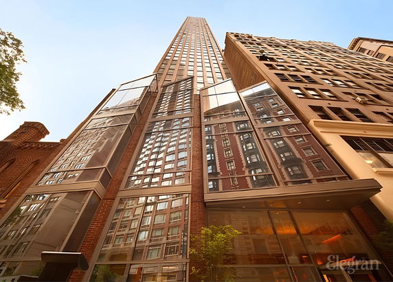 Front view of a high-rise building with modern glass and brick facade.