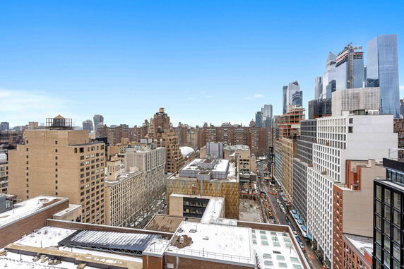 Panoramic view of city buildings from a high vantage point.