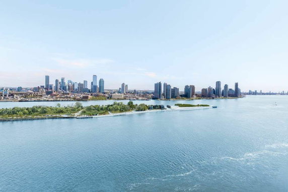 Panoramic view of a city skyline and waterfront.