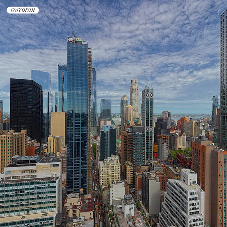 Panoramic view of a cityscape with tall skyscrapers and a cloudy sky.