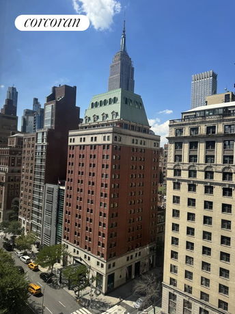 Panoramic view of urban buildings with a tall skyscraper in the background.
