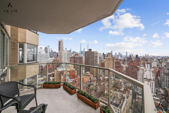 Panoramic view of a city skyline from a balcony.