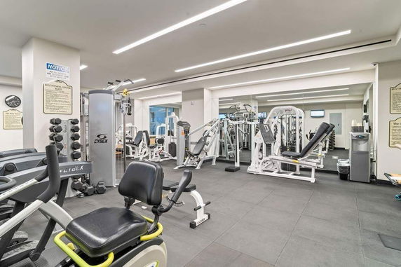 Interior view of a gym with various exercise machines and equipment.