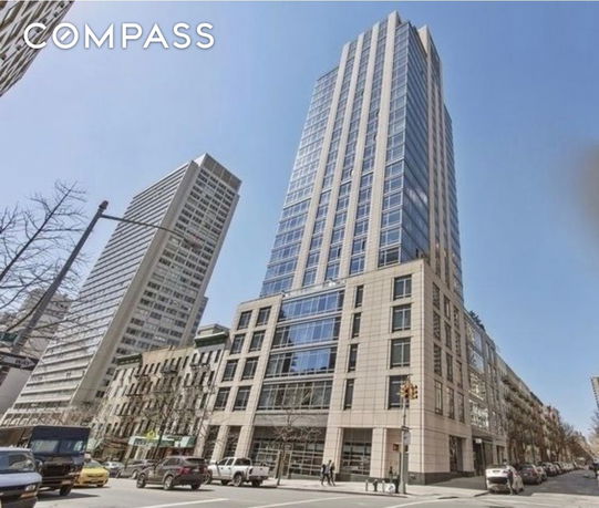 Front view of a tall residential building in an urban setting.