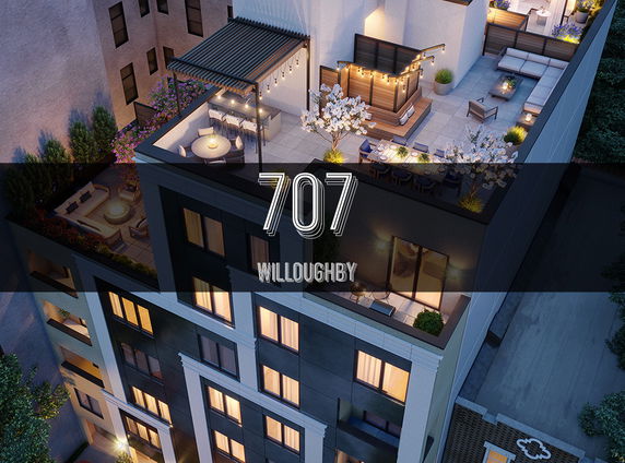 Rooftop area of a building with seating and decorative lights.