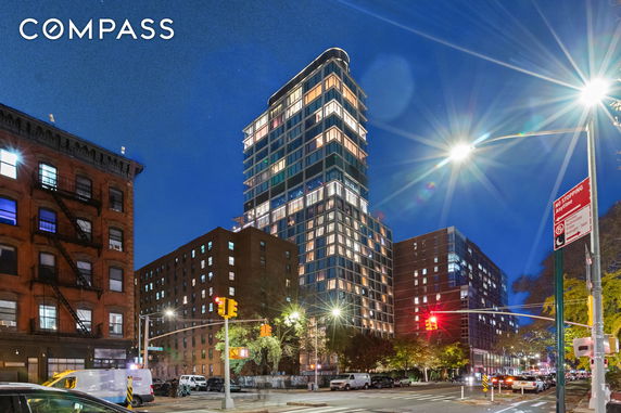 Front view of a multi-story modern building at night.