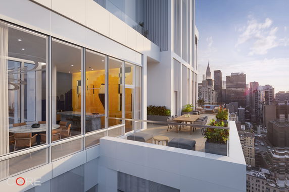 View from a modern building balcony overlooking a city skyline.