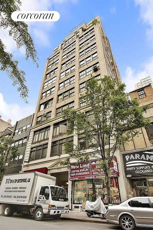 Front view of a multi-story commercial building with street-level shops.