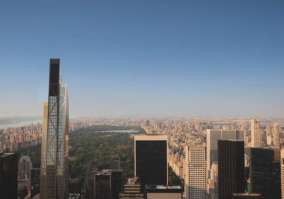 Panoramic view of a cityscape with tall buildings and a large park in the center.